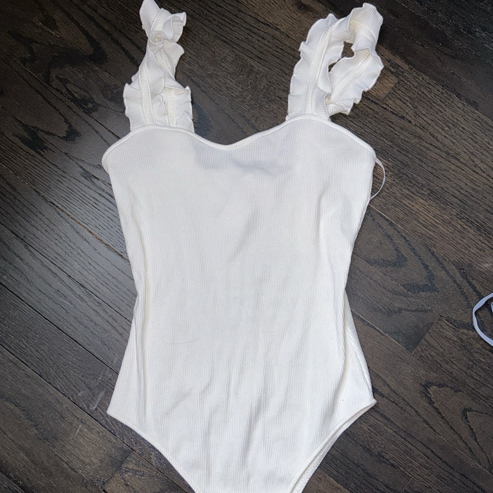 Wild Honey- Ribbed white bodysuit with sweetheart neckline and ruffled straps.